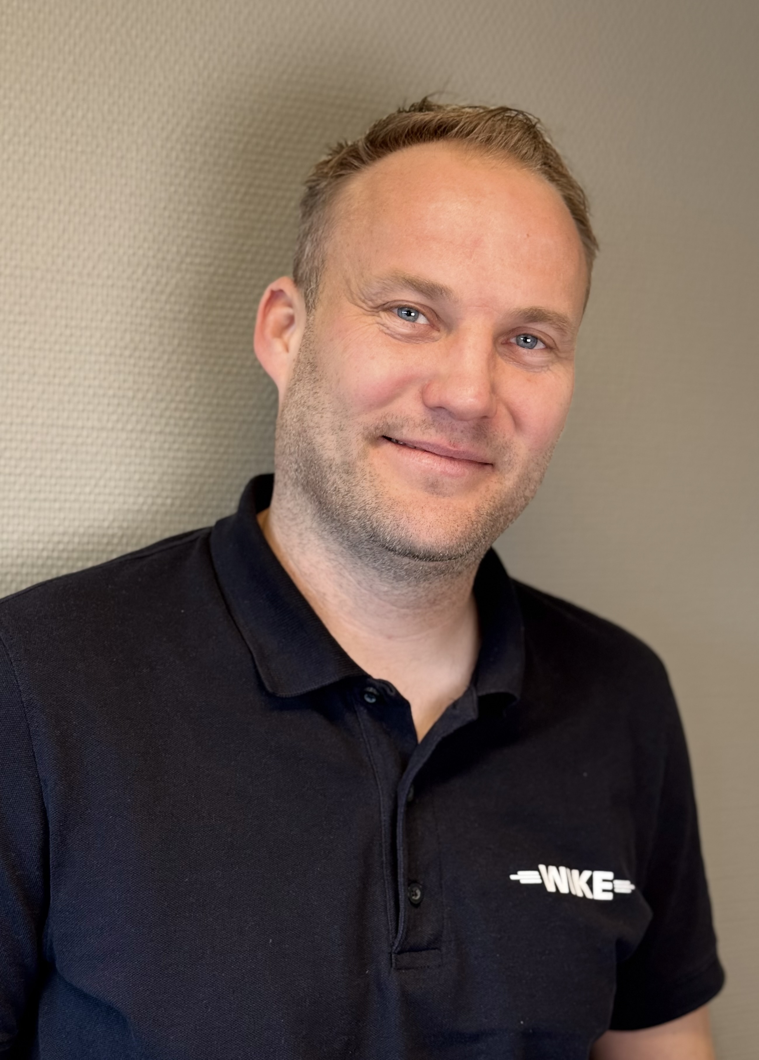 Nærbilde av gravemaskinskuffe som spruter jord.